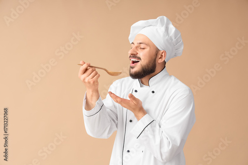 Male chef with spoon on bei...