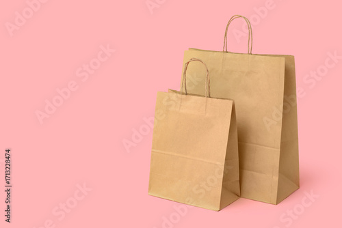 Paper shopping bags on pink...