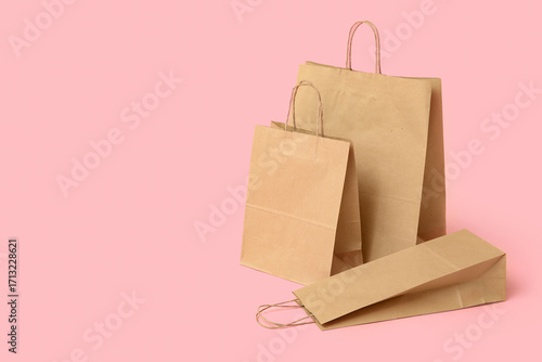 Paper shopping bags on pink...