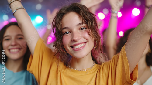 Energetic group of teens celebrating together in joyful dance and applause
