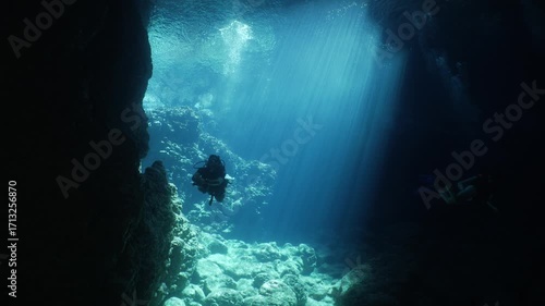 Wallpaper Mural cave diving underwater scuba divers exploring caves and having fun ocean scenery sun beams and rays background Torontodigital.ca