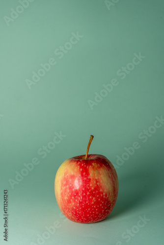 red apple on a green background