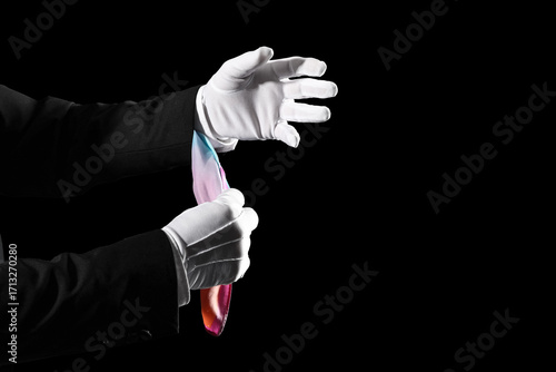 Foto Male magician's hands taking cloth out of sleeve on black background