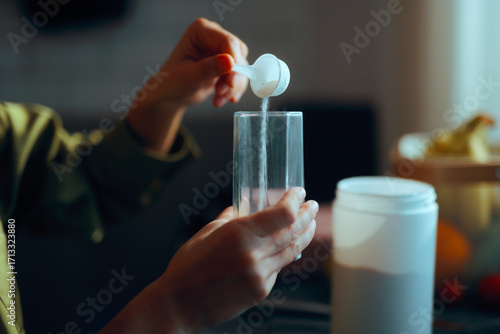 Canvastavla Person Pours a Spoonful of Collagen into a Glass to Prepare the Drink