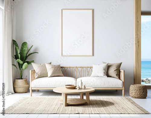 Interior shot of minimalist boho beach living room with cream pastel themed furniture and blank vertical white canvas