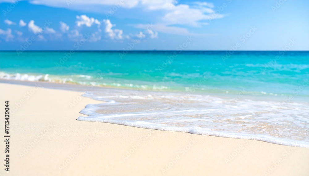 Fototapeta premium A serene background of a soft-focus beach with gentle wave foam.