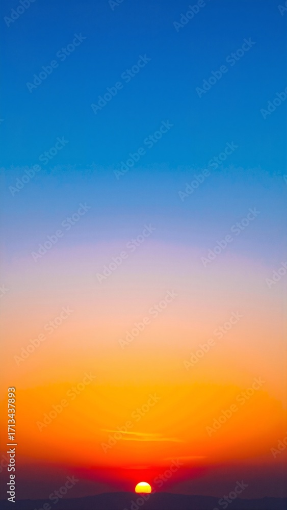Fototapeta premium A breathtaking sunset paints the sky in vibrant hues of orange, pink, and purple, as the sun dips below the horizon, casting a warm glow over the landscape.