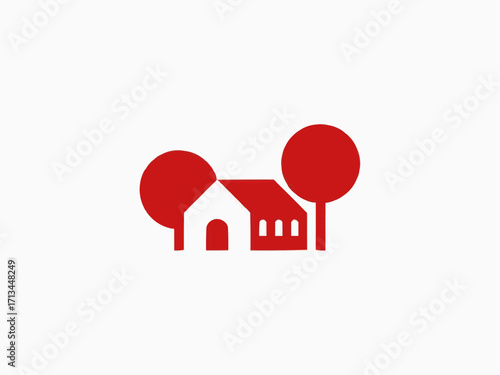 Charming red house with two trees evokes cozy home feeling and simple living dreams