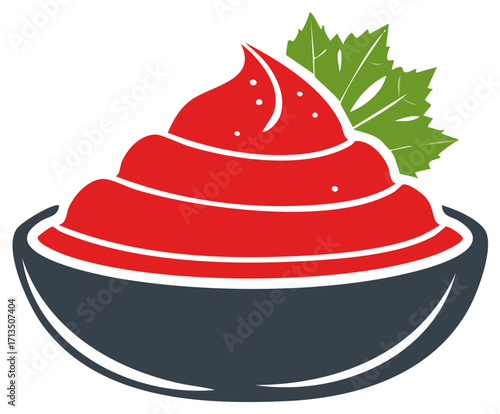Savory red food dip or sauce in a dark serving bowl with fresh green leaves