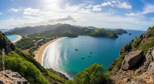 Panoramic view of a tropical bay with turquoise water and sandy beach.