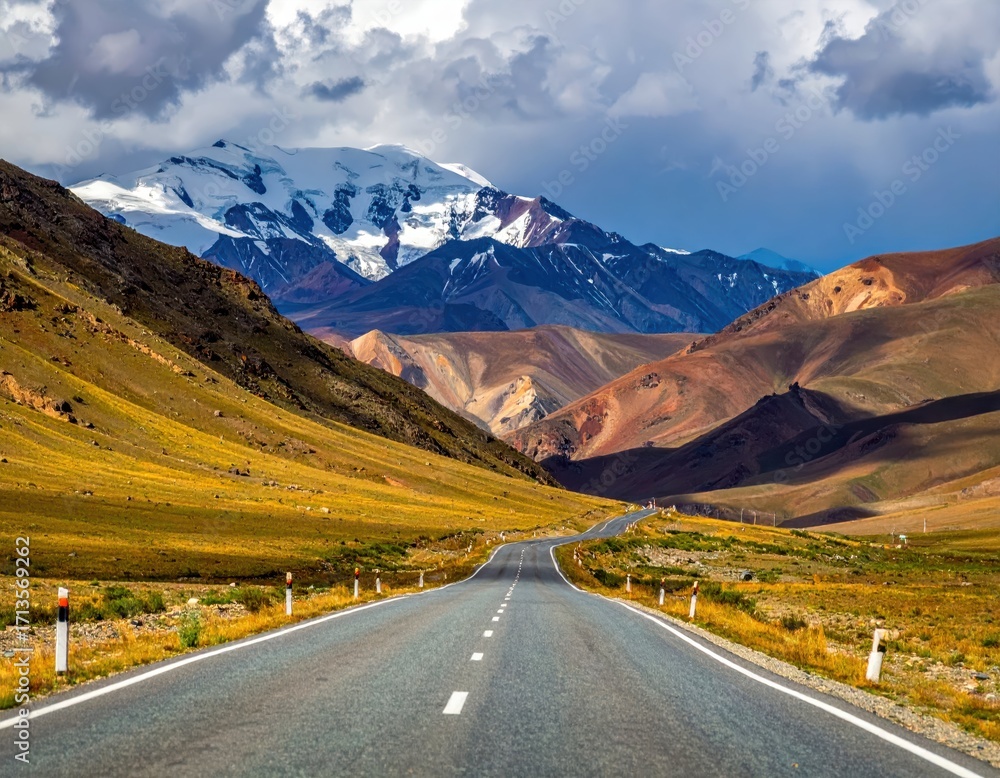 Fototapeta premium Scenic Mountain Road with Majestic Peaks and Dramatic Skies
