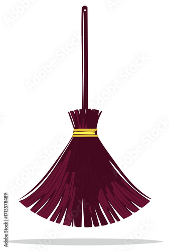 Traditional Halloween witch broom with a long handle and dark bristles tied with a gold band