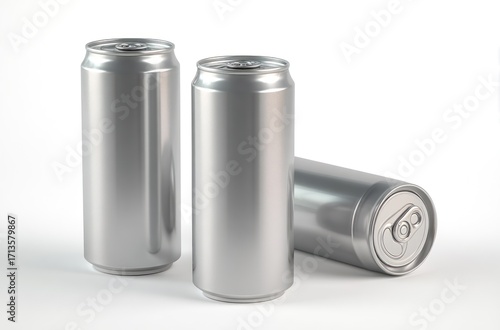 Three plain silver aluminum cans stand and lay on a white surface, reflecting light, with seamless look