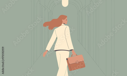 Woman in a suit walking down a hallway with a briefcase.