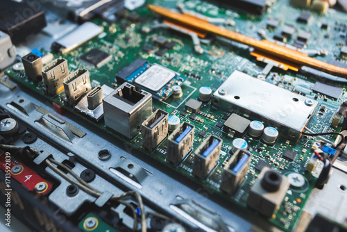 Close-up image of an all-in-one computer interior showing the motherboard, heat pipe cooling system, RAM slot, processor, and electronic components. Inside View of All-in-One Computer Motherboard