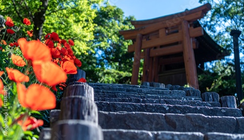 Stone steps leading to a shrine, surrounded by flowers