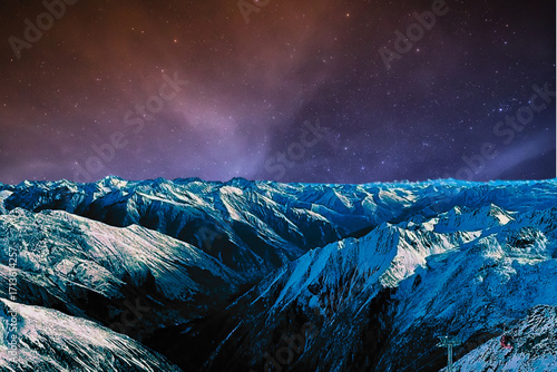 night view of snowy mountain range and milky way. starry night sky with stars and moon. beautiful landscape with snowy mountain peaks in winter night.