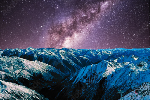 night view of snowy mountain range and milky way. starry night sky with stars and moon. beautiful landscape with snowy mountain peaks in winter night.