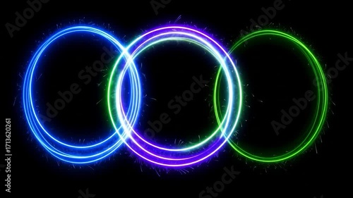 Three overlapping circles of light, blue, green, purple, with spark-like emanations, against black