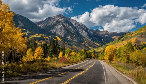 Mountain road winding through vibrant fall foliage