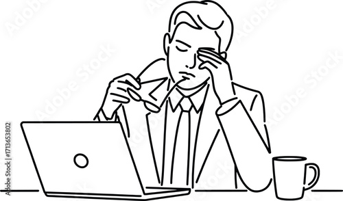 Tired businessman rubbing eyes at desk with laptop and coffee mug struggling with work exhaustion