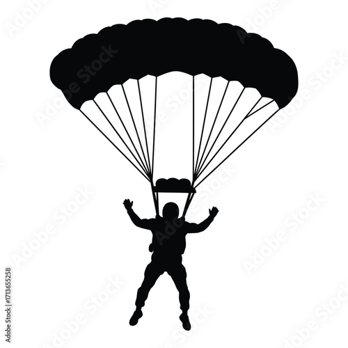 Silhouette of a skydiver descending under a parachute in mid-air