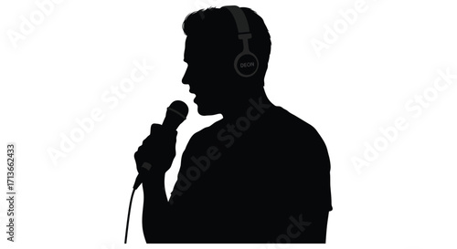Silhouette of a man singing into a microphone while wearing headphones