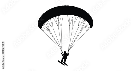 Silhouette of a paraglider soaring through the sky with a skier