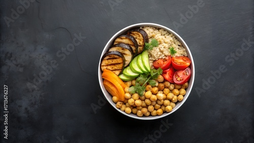 Healthy quinoa bowl with grilled vegetables and chickpeas, overhead view on dark concrete surface, clean minimal setup, space for text, colorful nutritious meal, top-down modern food photography