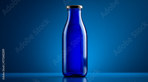 Wallpaper Mural Close up studio shot of a blue glass bottle with a silver lid against a blue background Torontodigital.ca