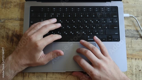 Hands busy working laptop keyboard. Hands touchpad. Laptop computer keyboard on wooden table, remote job, hands typing