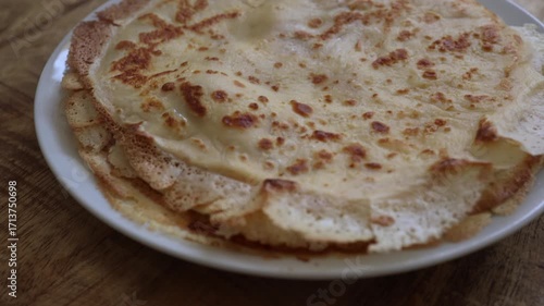 Freshly baked crepes, crepes in tack. Cooking pancakes at home, homemade thin pancakes. Hot crepes national food bliny