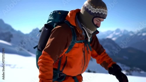 Wallpaper Mural A climber in bright orange gear navigating snowy mountains under a clear blue sky Torontodigital.ca