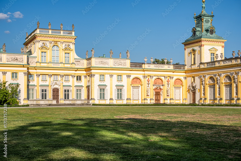 Obraz premium Warsaw, Poland, Wilanow, Majestic palace with intricate architecture and lush green lawns, showcasing royal heritage and summer beauty, perfect for travel exploration and cultural legacy appreciation