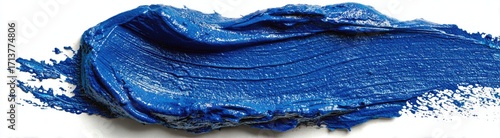 A vibrant, textured smear of cobalt blue paint on a white background, showing brushstrokes and a slightly uneven edge