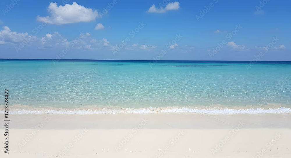 Obraz premium Crystal Clear Turquoise Ocean Water and Sandy Beach Under a Bright Blue Sky with Scattered Clouds