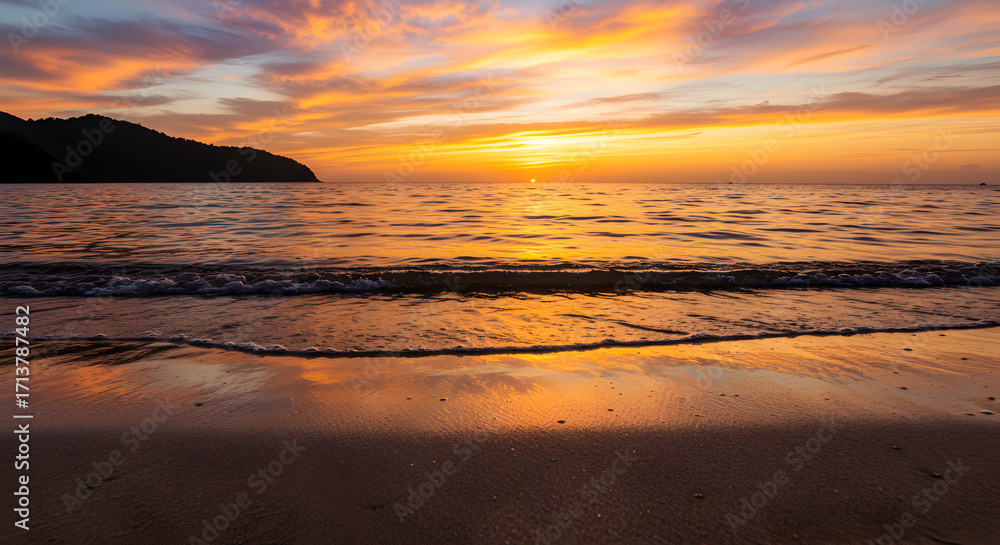 Obraz premium Scenic Beach at Sunset with Vibrant Orange Sky and Reflected Light on Wet Sand