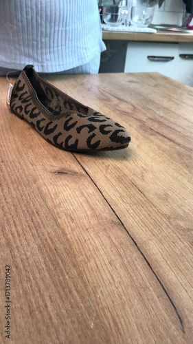 Leopard print womens summer sandals. Woman reviewing shoes for social media. Vertical video.