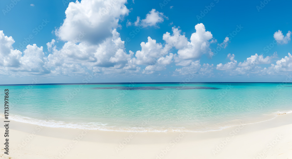 Fototapeta premium Serene Clear Turquoise Water and White Sandy Beach Under Sunny Blue Sky with Clouds