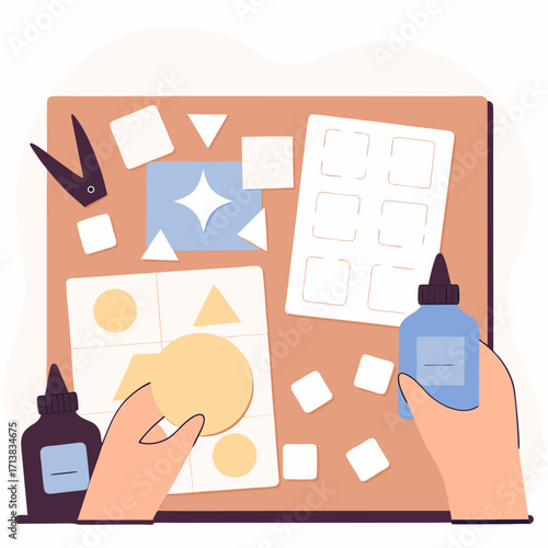 Crafting with colorful paper shapes and glue on a work table  