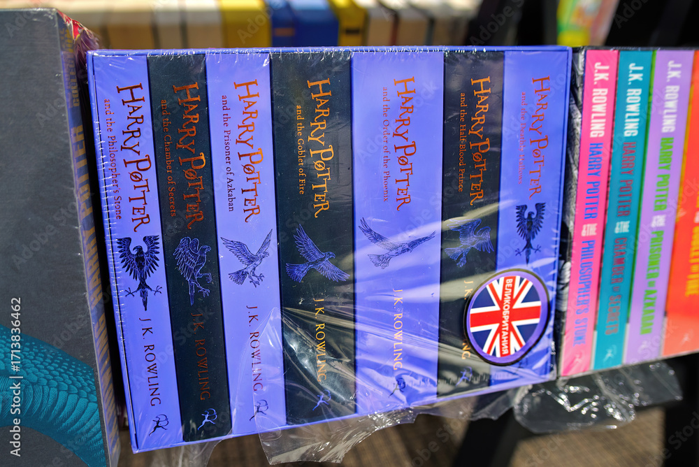 Naklejka premium Minsk, Belarus. Jan 12, 2025. Harry Potter saga books written by J.K. Rowling stacked and displayed on bookshelf in bookstore interior, classic english literature editions. Selective focus