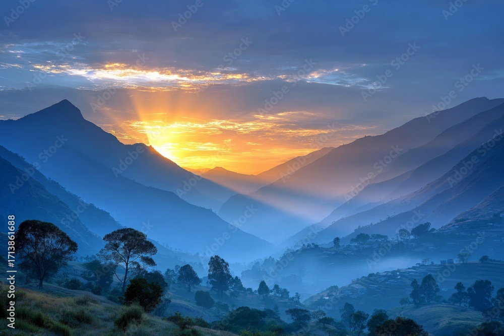 Obraz premium Majestic mountain sunrise over misty valleys and peaks illuminating the sky with warm colors