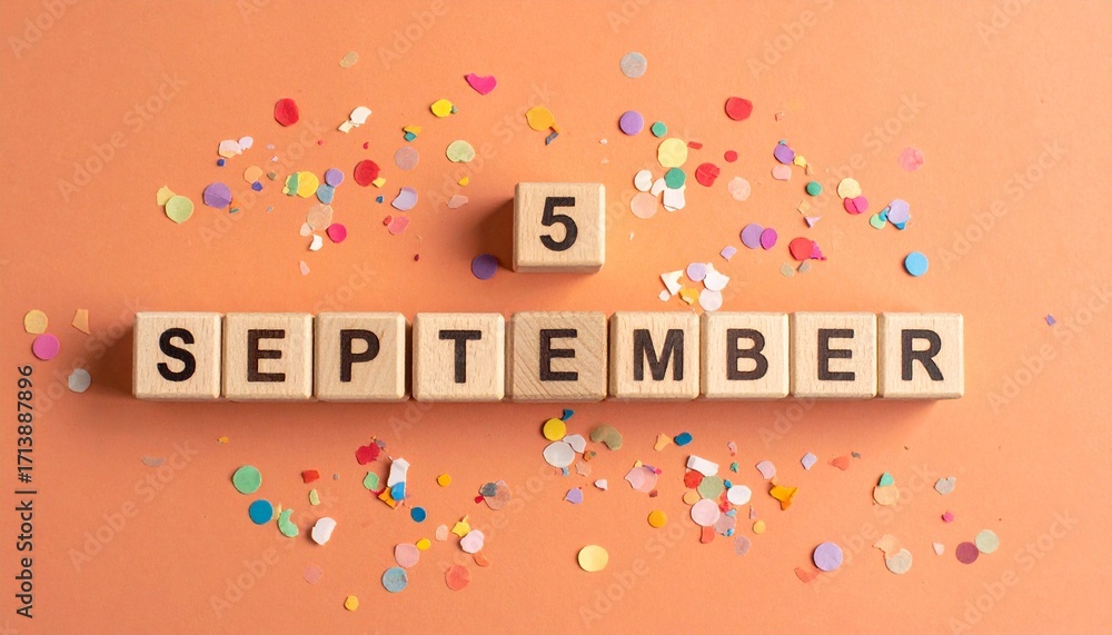 Fototapeta premium Wooden Blocks with Date 5 September. Calendar for birthday or anniversary on solid colored background with confetti