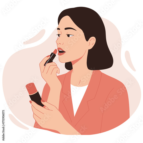 Woman applying lipstick while looking in the mirror indoors  