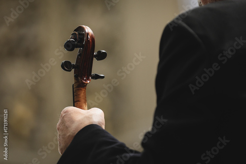 Unrecognizable violin player performing in orchestra ensemble