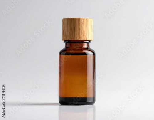 A simple, amber-colored glass bottle with a light wooden cap stands out against a neutral background.
