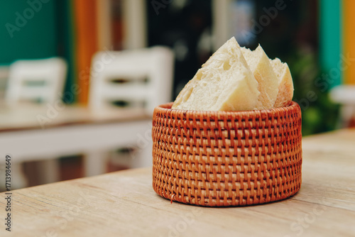 Close up flatlay top view of a basket of bread or sourdough on a table.