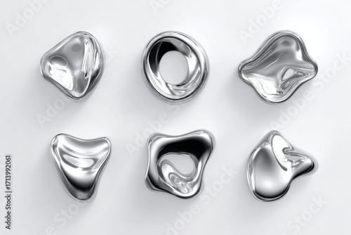 Abstract metallic forms arranged on a light gray surface.  Six smooth,