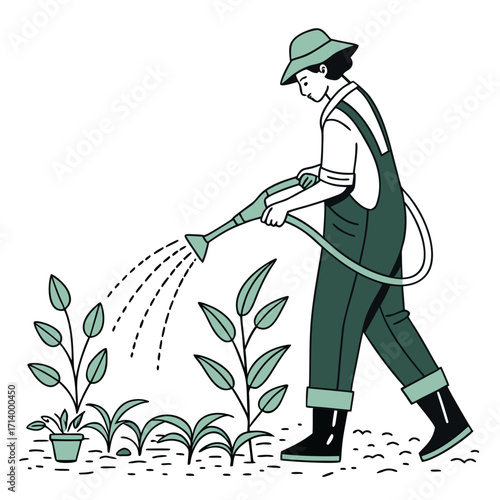 Gardener in overalls and hat watering young plants with a watering can and hose in a garden