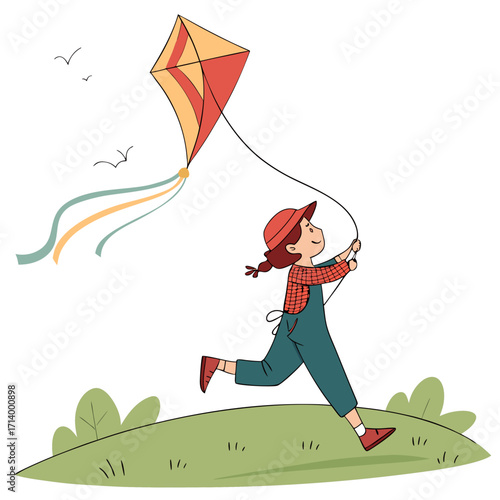 Joyful young girl in overalls running across a grassy hill flying a colorful kite